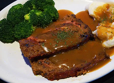A plate of food with meat and broccoli.
