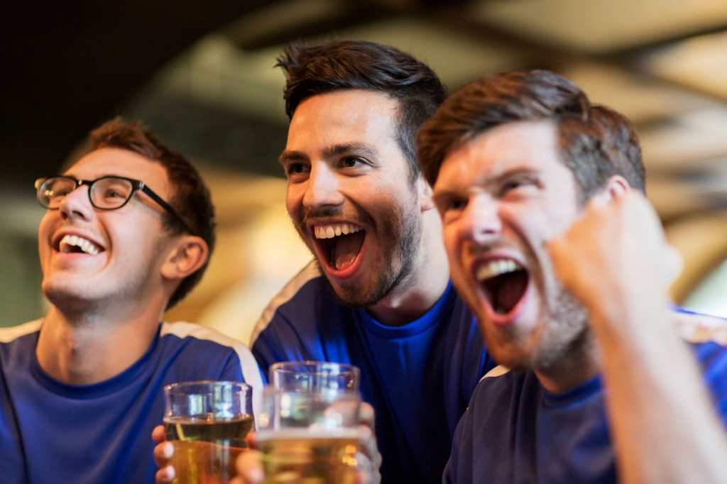 Three men are drinking beer and laughing.